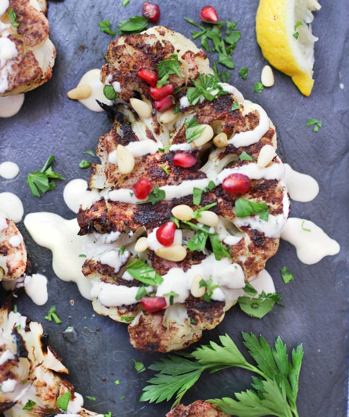 Grilled cauliflower shawarma with lemony tahini sauce, pine nuts and pomegranate seeds