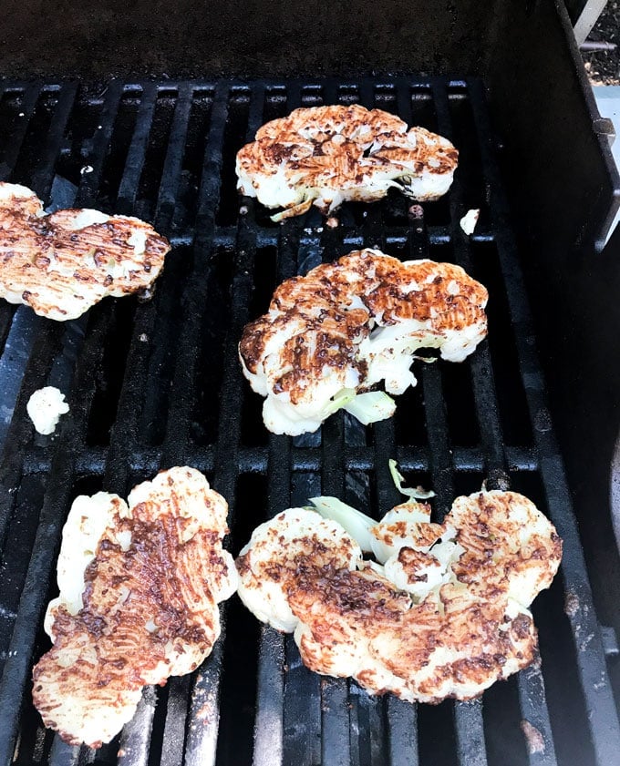 Cauliflower shawarma cooking on the grill