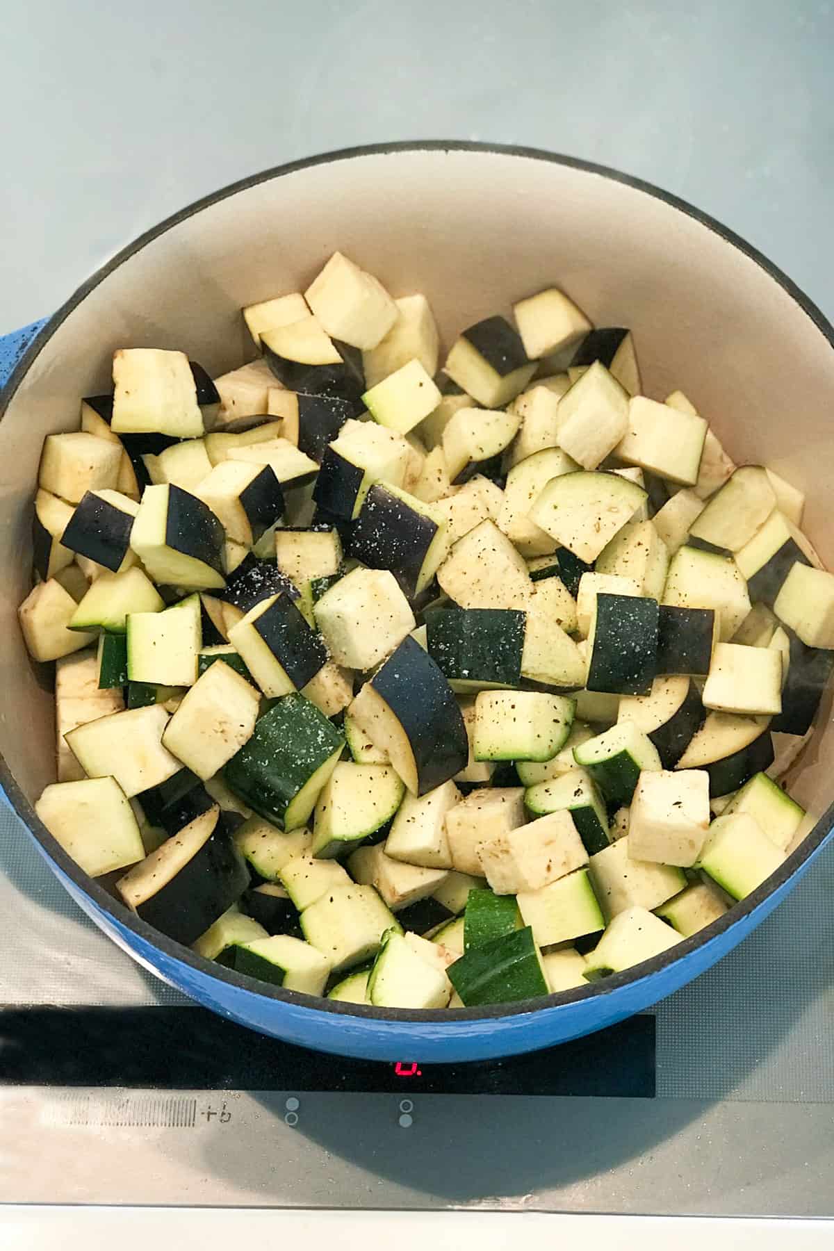 cubes of eggplant and zucchini in a dutch oven