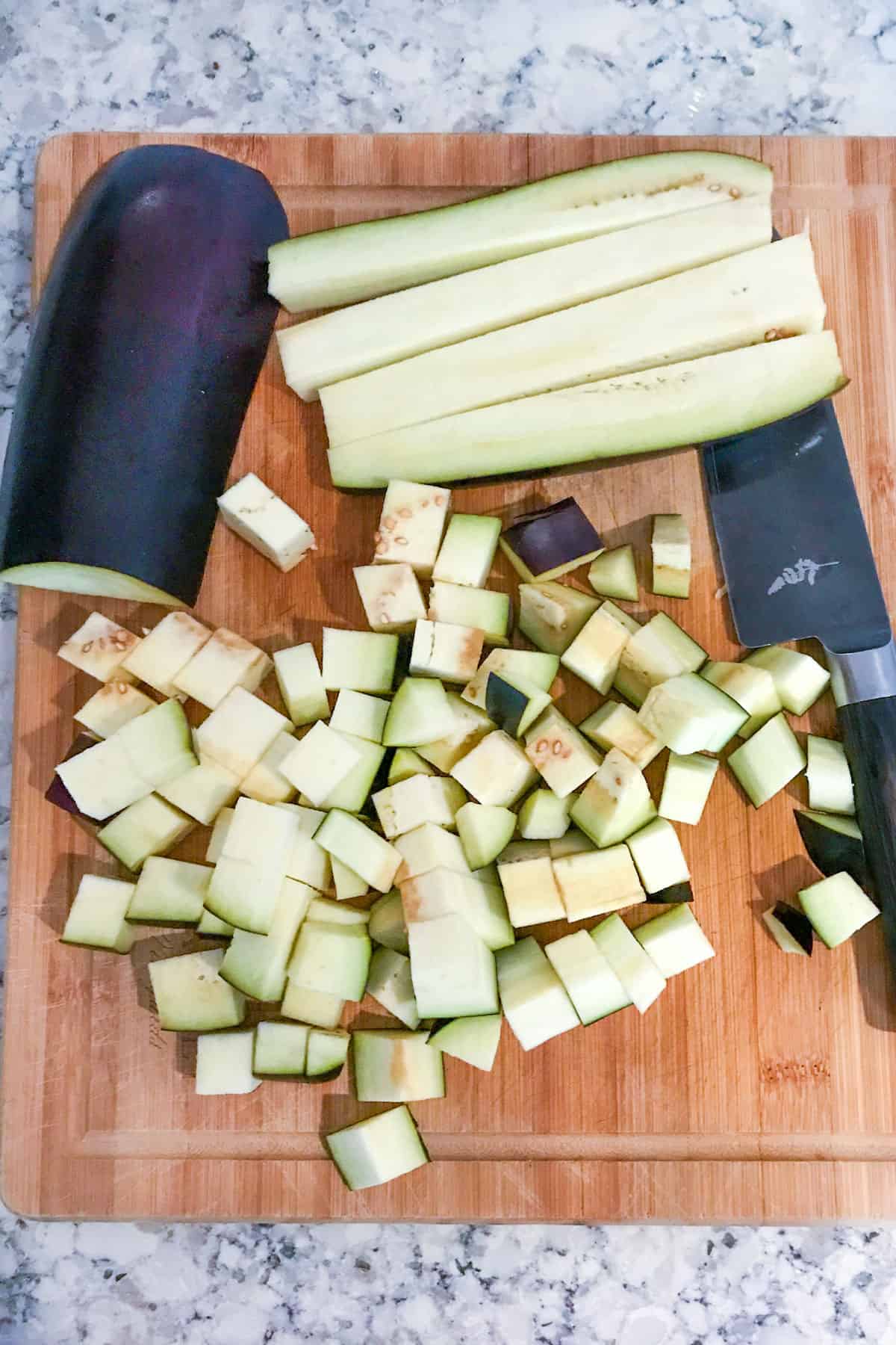 an eggplant cut into strips and then cubed.