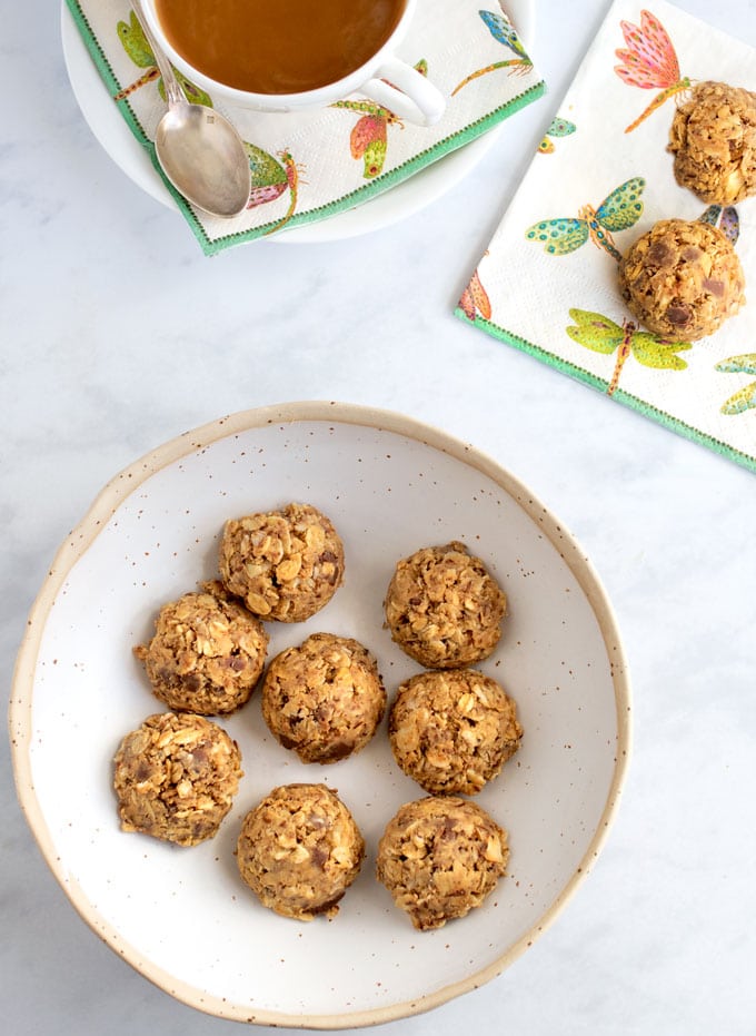 a bowl of no bake oatmeal peanut butter energy bites and a cup of coffee