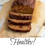 a loaf of pumpkin bread on a wooden cutting board with 3 slices cut