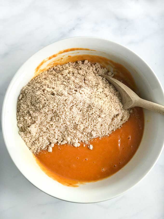 A bowl with ingredients for making healthy pumpkin bread with almond flour