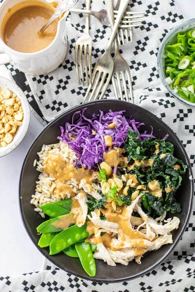 Close up of a fork in twisted noodles in a Thai noodle salad bowl