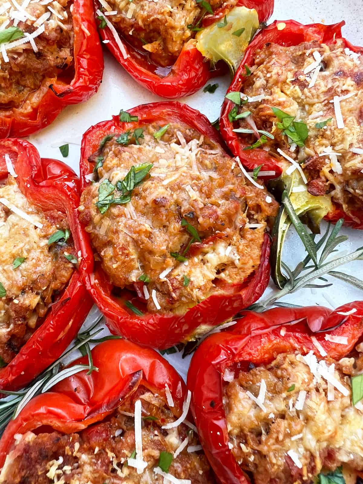 stuffed red bell peppers with meaty stuffing toped with parmesan cheese and chopped parsley.