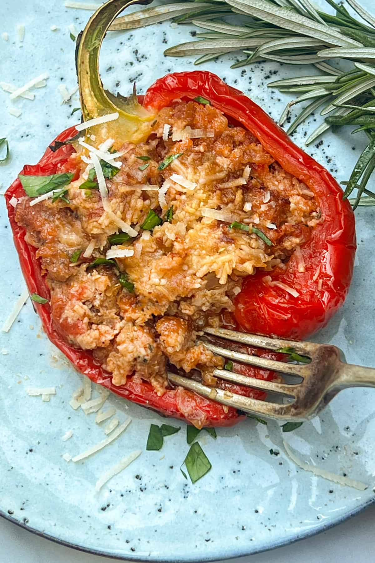 half of a red bell pepper stuffed with pork and melted parmesan cheese.