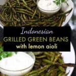 grilled green beans in a white bowl with lemon aioli dipping sauce in a small bowl