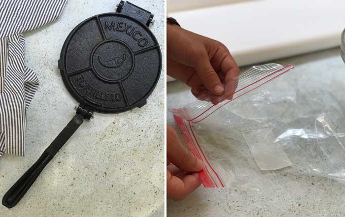 A black cast iron tortilla press and a ziploc bag that has been cut down the sides to line the press