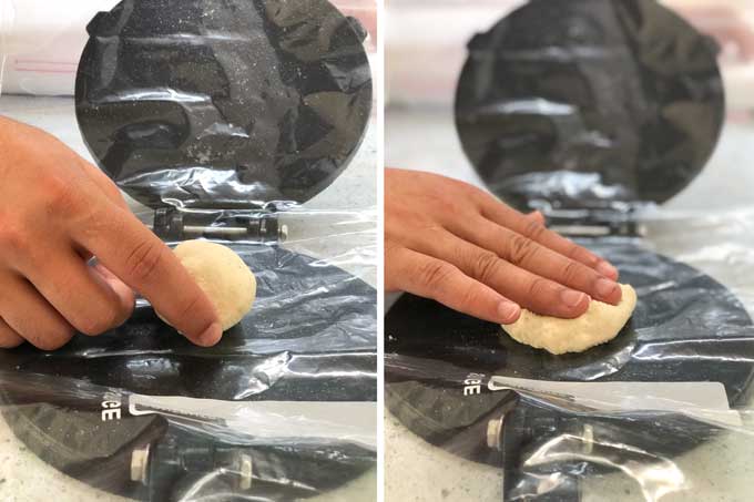 a hand placing a ball of dough in a tortilla press and pushing it down into the press 