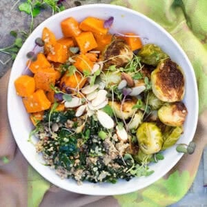 buddha bowl with roasted sweet potatoes, roasted brussels sprouts, kale and quinoa.