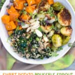 pinterest pin: white buddha bowl filled with roasted sweet potatoes and brussels sprouts, quinoa and wilted kale
