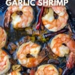 half a dozen sautéd shrimp in a cast iron skillet with garlic and a few small red chilies.