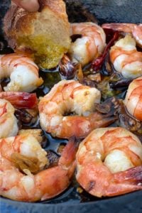 Close up of a cast iron skillet with 8 spicy garlic shrimp