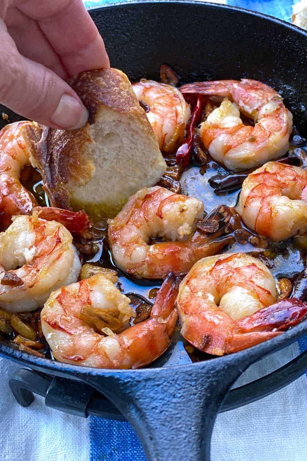 Close up of a cast iron skillet with 8 spicy garlic shrimp