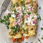 2 vegetarian Enchiladas Verdes with sweet potatoes and brussels sprouts