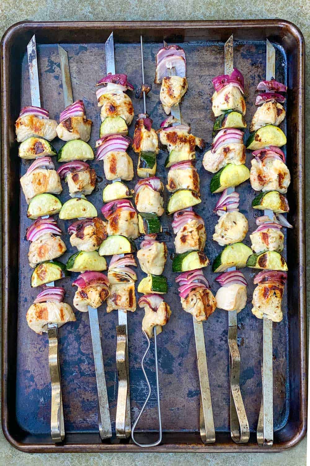7 grilled skewers of chicken souvlaki with zucchini and red onions