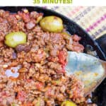 Pinterest pin: black skillet filled with ground beef stew with olives