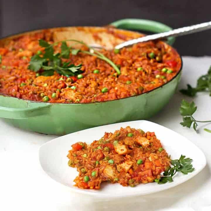 Jollof rice with chicken in a Dutch oven.