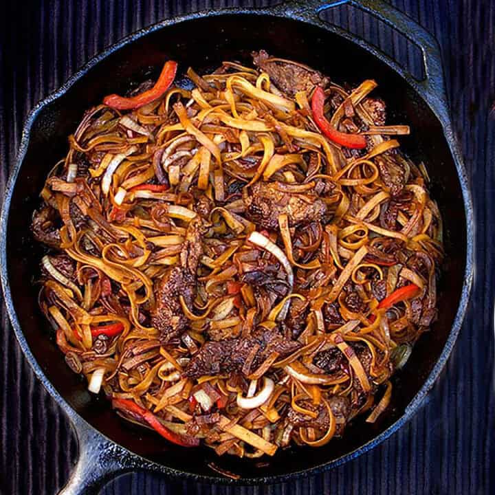 chinese beef chow fun in a cast iron skillet