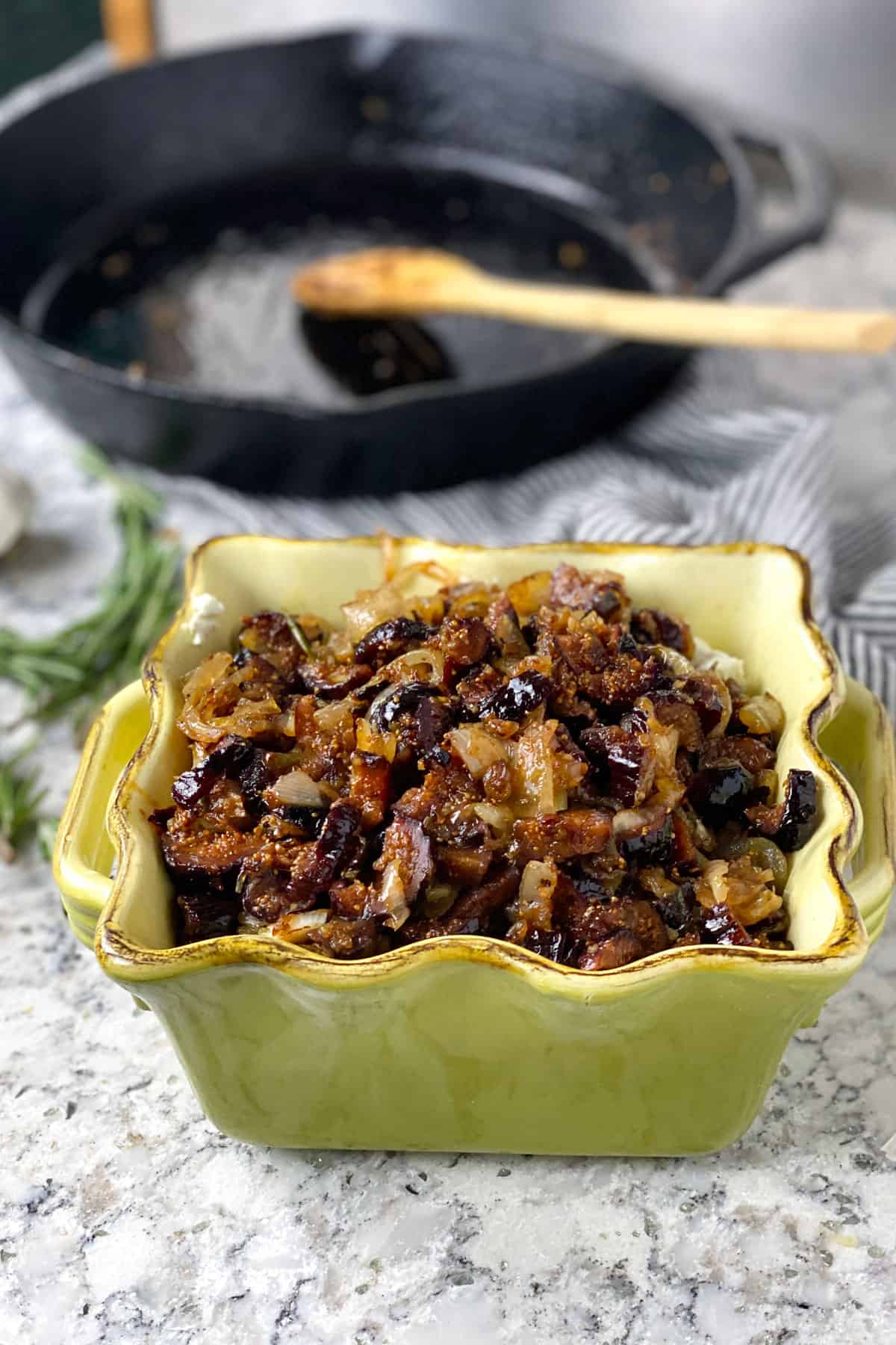 Goat cheese in a casserole with caramelized onions and figs on top