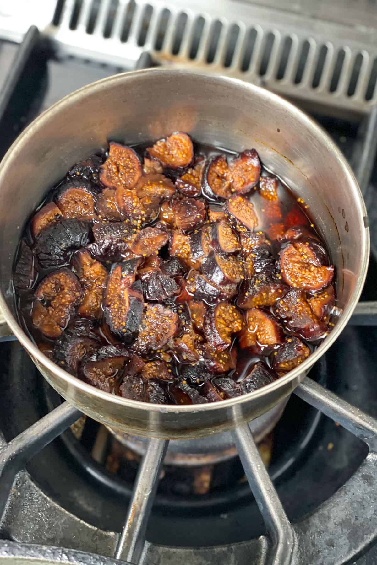 Chopped dried mission figs in a pot of liquid