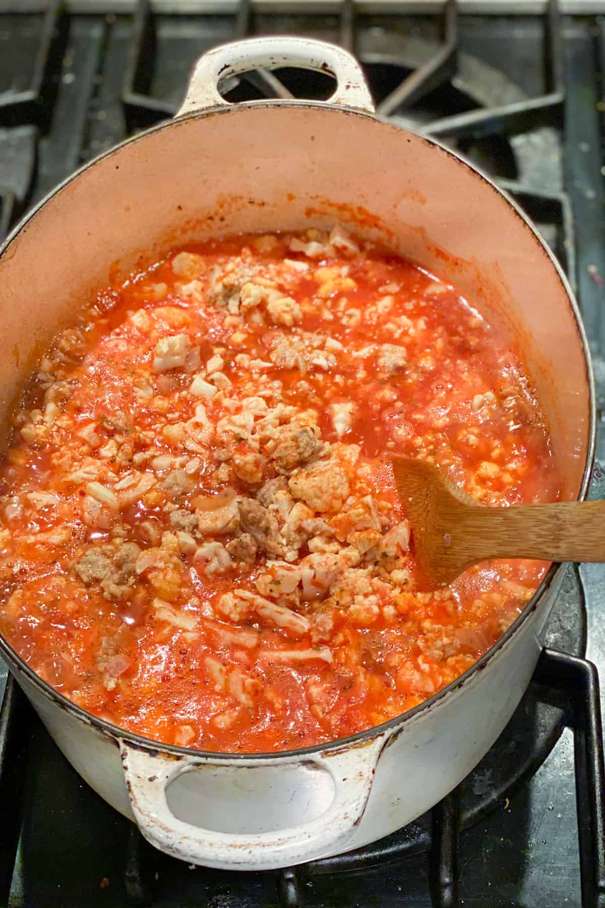 chunky ground turkey soup in tomato broth in a dutch oven.