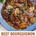 pinterest pin: blue bowl filled with beef bourguignon