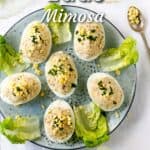6 deviled eggs stuffed with chopped egg and tuna, on a plate with lettuce leaves