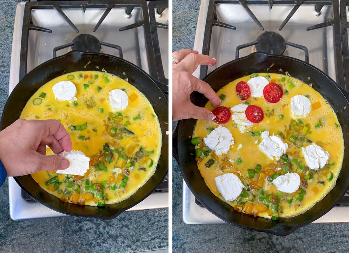 Cast iron skillet filled with sautéed chopped asparagus and whisked eggs, with 3 rounds of goat cheese being added by hand, the next shot shows the skillet filled with 8 rounds of goat cheese over the eggs, and slices of cherry tomato are being added on top.