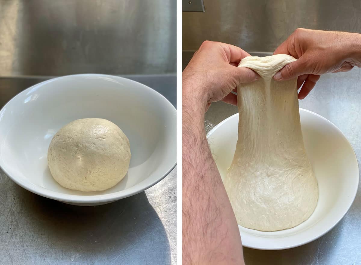 Ball of bialy dough in a white dough bowl, hands stretching the dough to demonstrate the stretch and fold technique