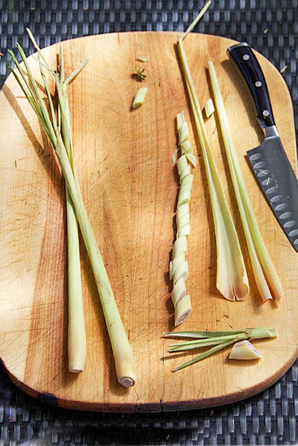talks of lemongrass in different stages of being cut that show how to cut lemongrass.