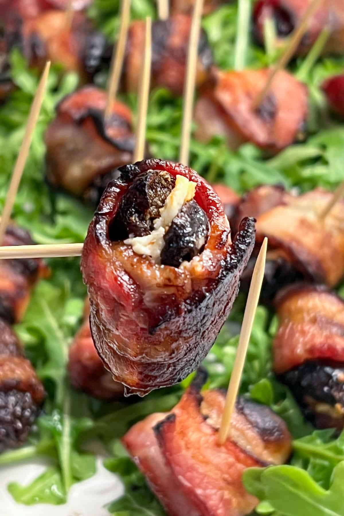 one bacon wrapped, goat-cheese-stuffed prune on a toothpick.