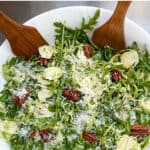 Pinterest pin: close up of a shaved brussels sprouts salad in a white bowl