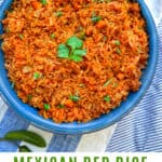 Pinterest pin, overhead shot of vivid orange Mexican red rice in a blue bowl with a sprig of cilantro in the middle