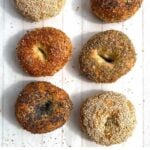 6 assorted bagels on a white wooden tray
