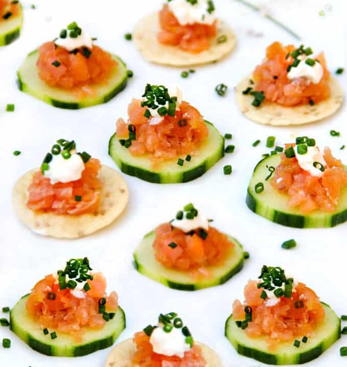 Finely chopped smoked salmon on 5 cucumber rounds and 5 rice crackers, topped with a little sour cream and chopped chives