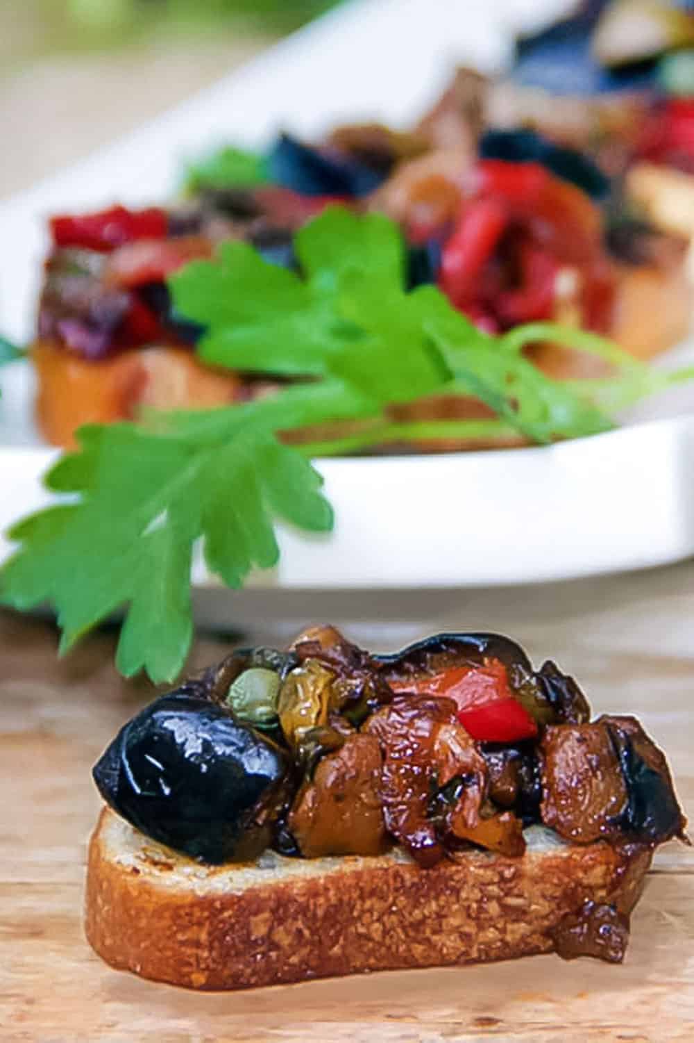 caponata -eggplant and vegetable relish - on toasted baguette slice.