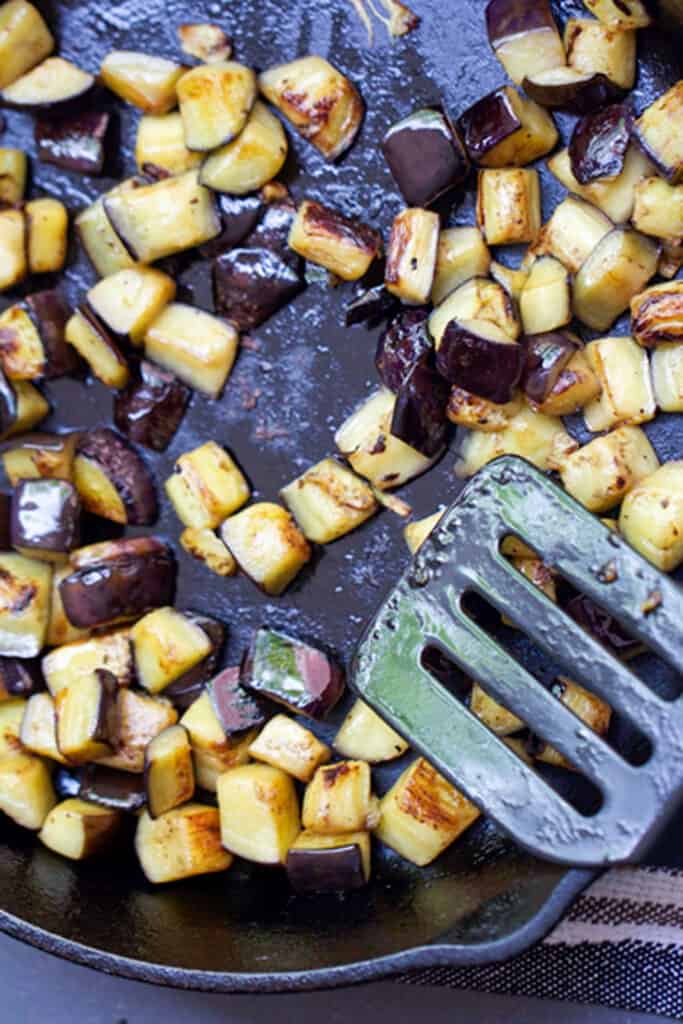 cubes of eggplant browning in a skillet