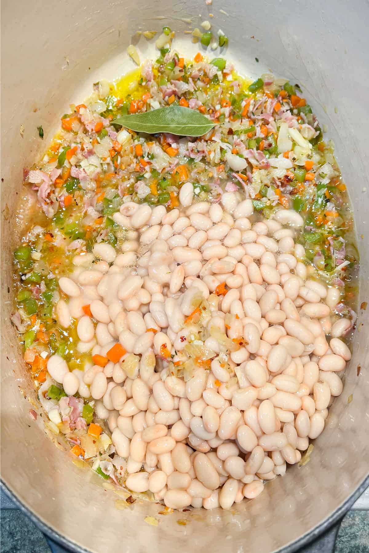 sautéd aromatic vegetables in a Dutch oven with canned white beans added