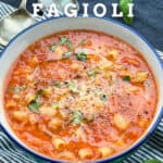 bowl of pasta e fagioli sprinkled with chopped basil and finely grated parmesan cheese