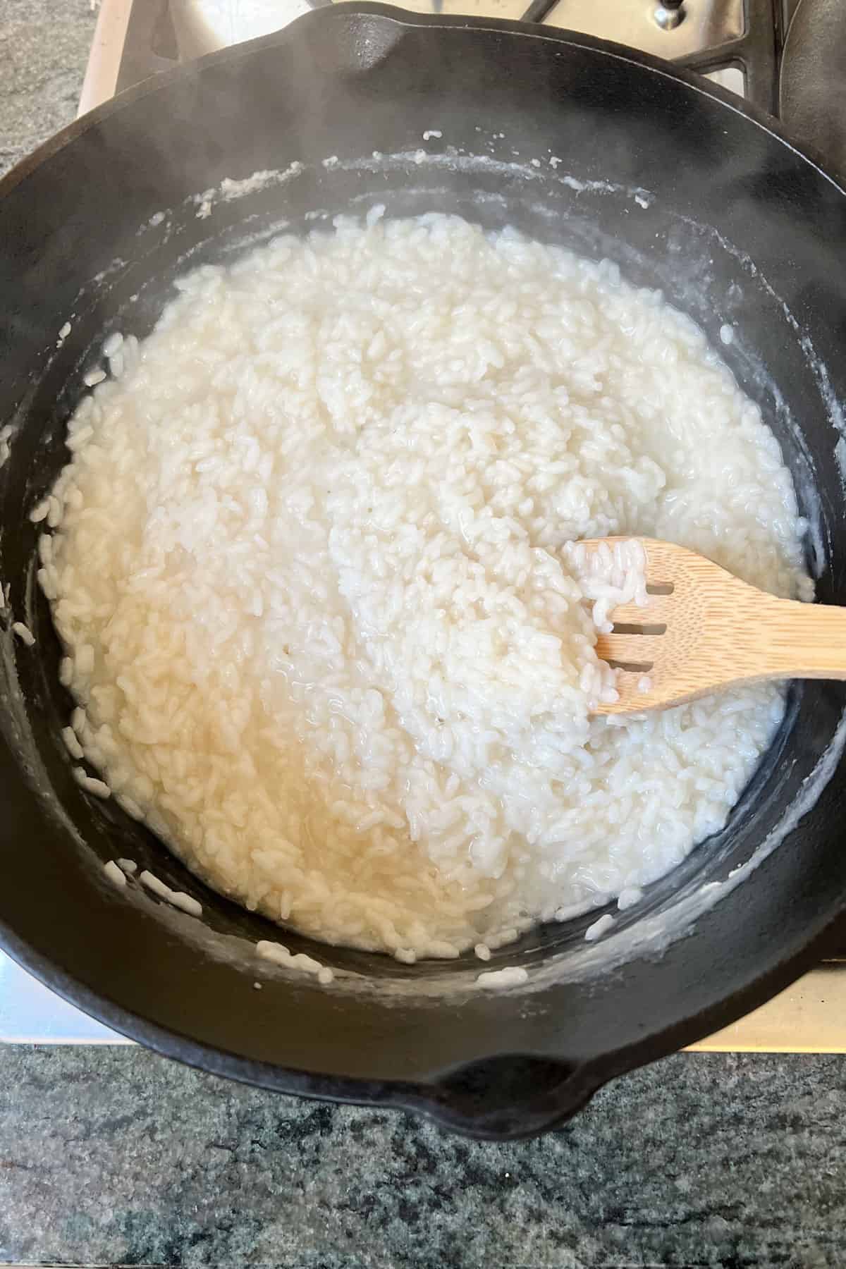 Cast iron dutch oven filled with creamy risotto