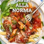 pinterest pin with overlay text on a bowl of pasta tossed with eggplant tomato sauce.