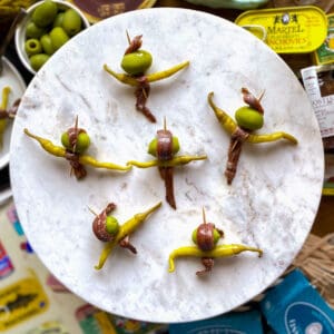 Six gilda pintxos (anchovy, olive, guindilla pepper skewers) on marble