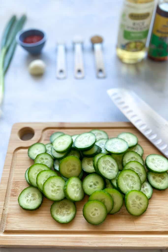 sliced cucumbers on a cutting board