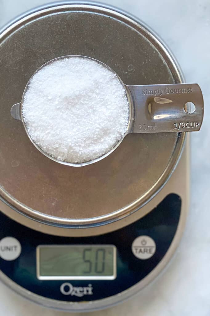 ⅓ cup of salt on a scale that reads 50 grams