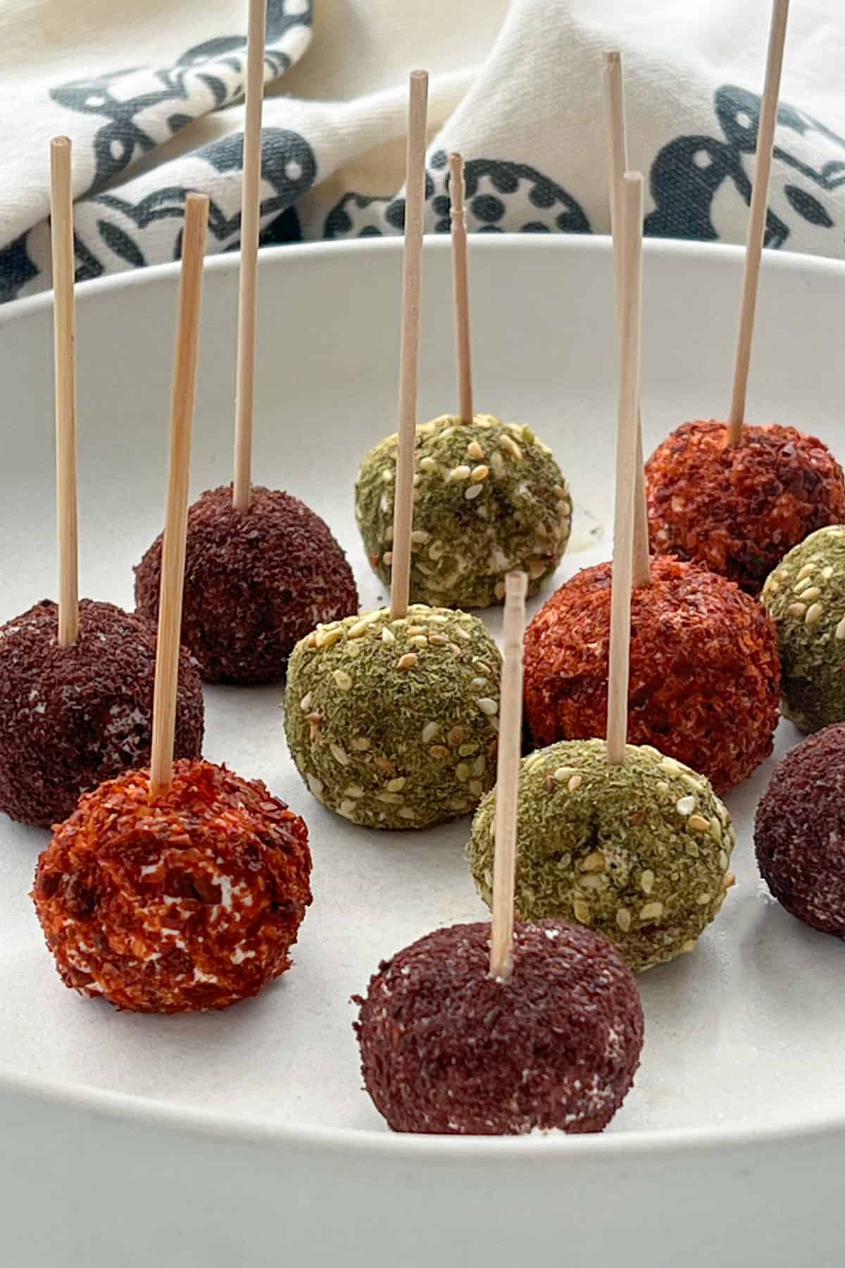 balls of labneh coated in various spices with toothpicks in them