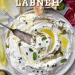 labneh in a bowl drizzled with olive oil and sprinkled with za'atar and chopped mint.