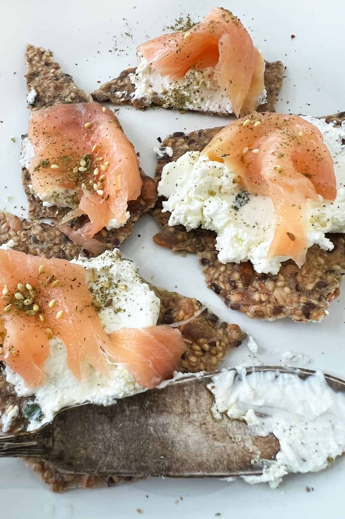 labneh on crackers with smoked salmon and za'atar and a labneh covered knife