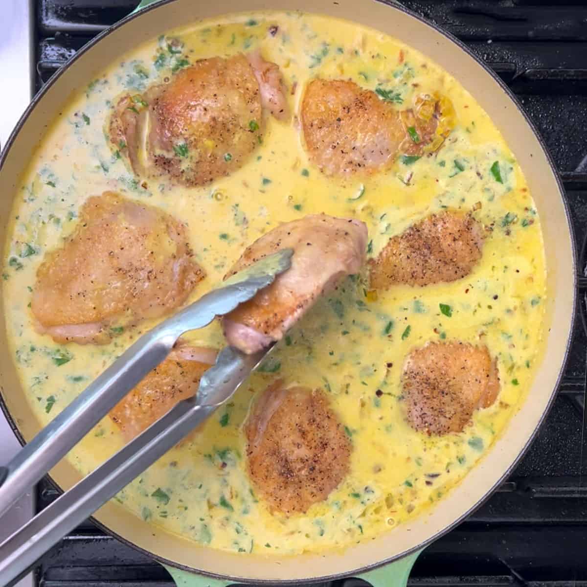 8 chicken thighs with golden brown skin added, skin side up in a single layer, to the rice and liquid in a shallow dutch oven.