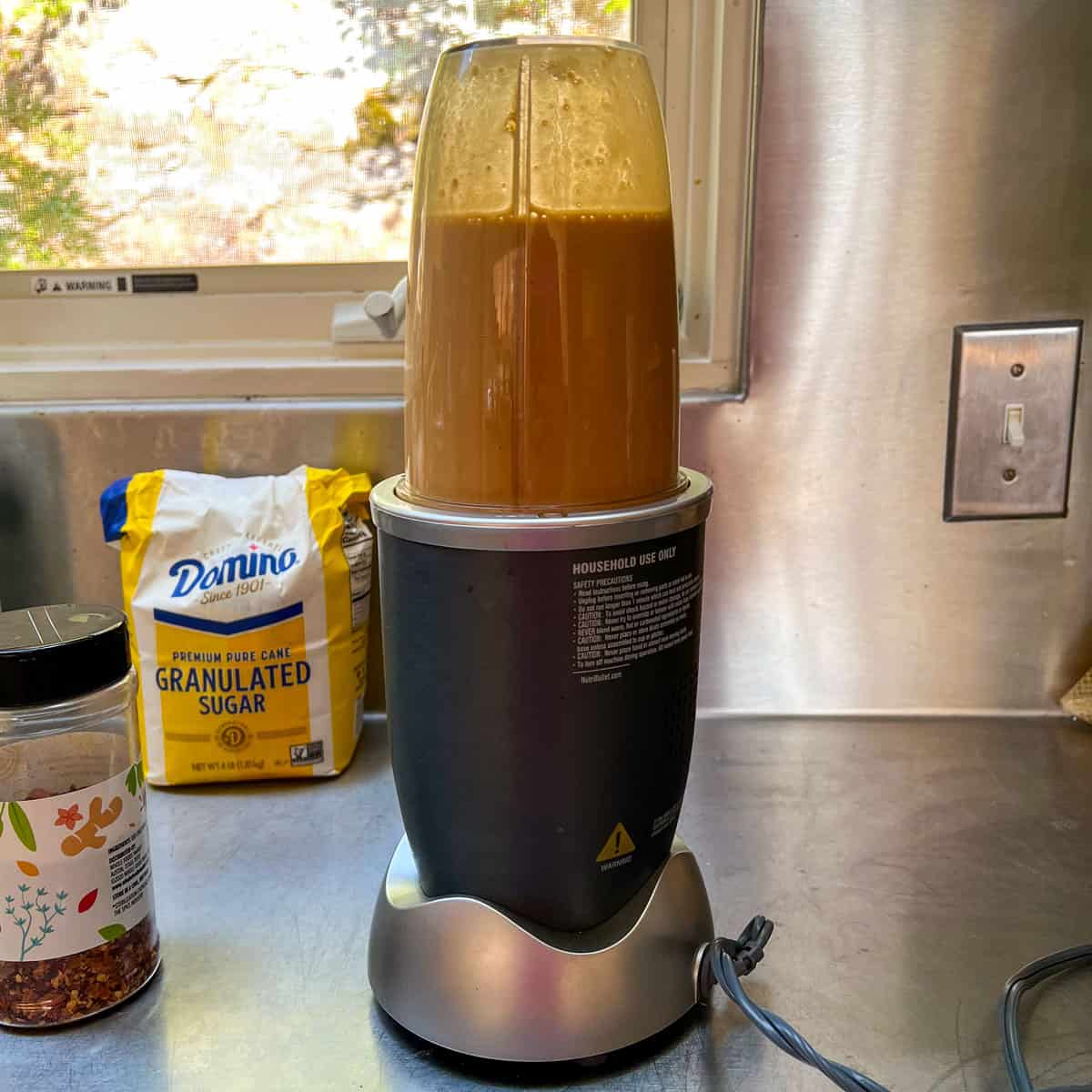 Nutribullet blender filled with apricot glaze mixture